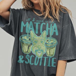 May include: Dark gray t-shirt with the text "all I need is my MATCHA & SCOTTIE" in teal. The graphic includes two matcha drinks and a green Scottie dog illustration.