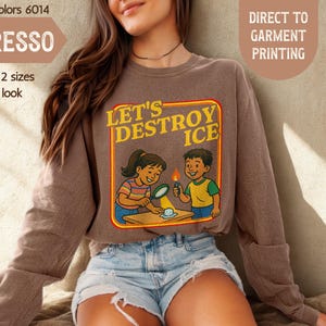 May include: Espresso-colored sweatshirt with the text "LET'S DESTROY ICE" and a graphic of two children experimenting. The sweatshirt is a Comfort Colors 6014, and the image also includes the text "DIRECT TO GARMENT PRINTING" and "MIND & HARMONY GIFTS".