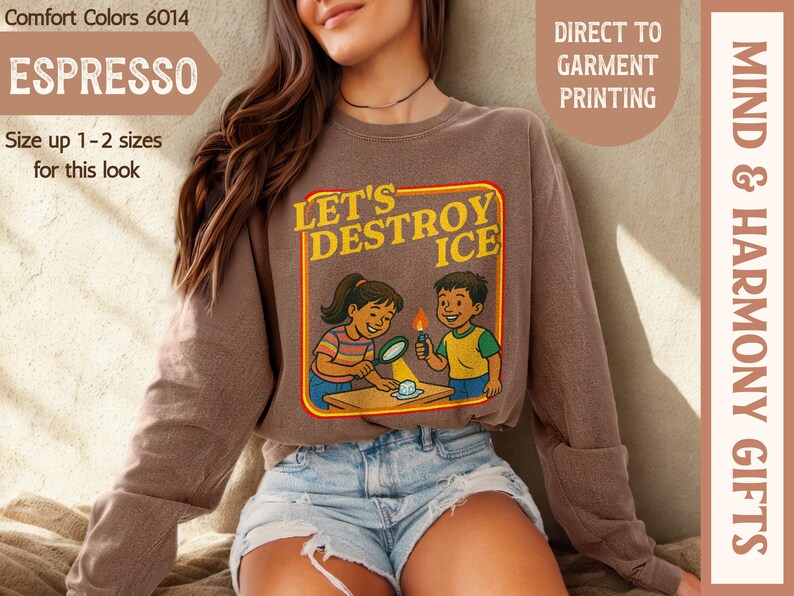 May include: Espresso-colored sweatshirt with the text "LET'S DESTROY ICE" and a graphic of two children experimenting. The sweatshirt is a Comfort Colors 6014, and the image also includes the text "DIRECT TO GARMENT PRINTING" and "MIND & HARMONY GIFTS".