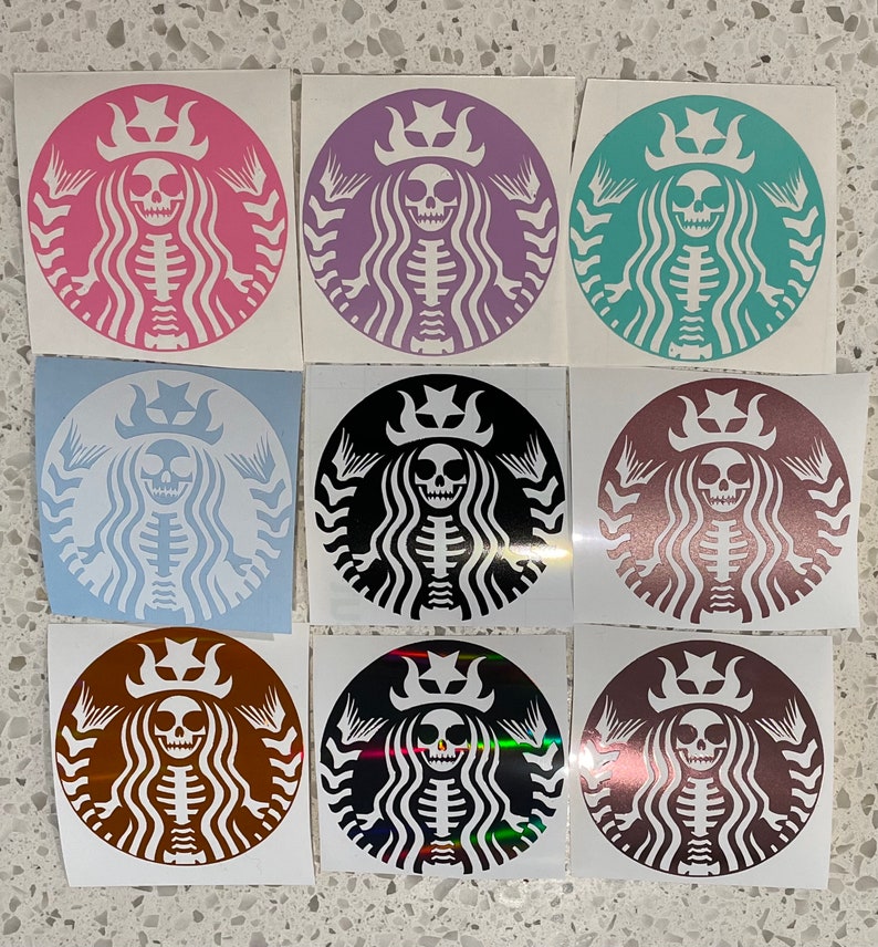 May include: Nine different coloured stickers featuring a skeleton wearing a crown and a mermaid tail. The stickers are in various colours including pink, purple, teal, blue, black, brown, and gold.