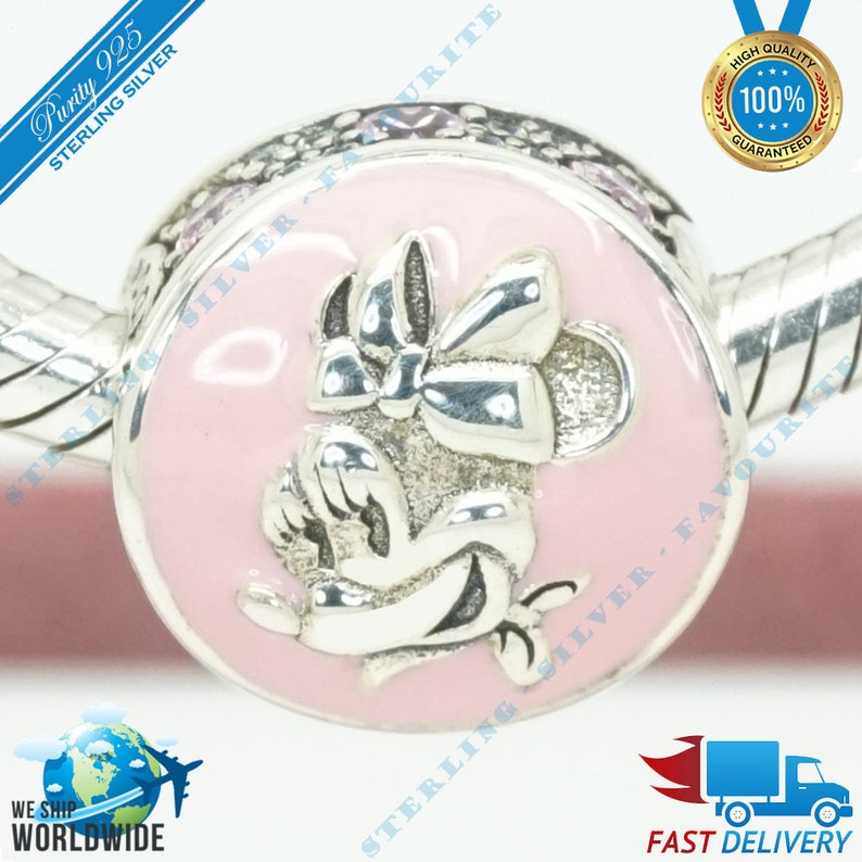 May include: Sterling silver charm featuring a pink enamel background with a silver Minnie Mouse design. The charm is attached to a silver bracelet.