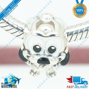 May include: Sterling silver charm featuring a cartoon dog with black eyes, a black nose, and white fur. The charm is attached to a silver bracelet.