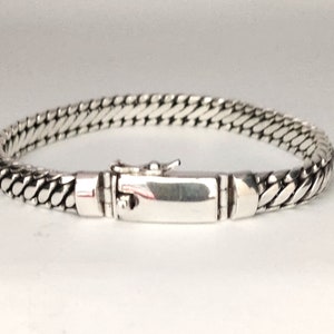 May include: A silver chain bracelet with a clasp closure.