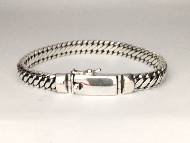 May include: A silver chain bracelet with a clasp closure.