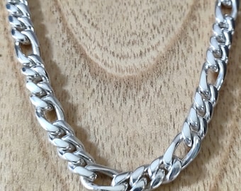 May include: A silver curb chain necklace with a classic design. The chain is made of interlocking links that create a strong and durable piece of jewelry.