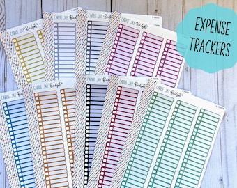 May include: A set of ten expense tracker stickers in various colors, including gold, gray, black, red, purple, and green. The stickers are labeled "Carrie Jay Budgets" and feature a grid of boxes with blank spaces for writing.