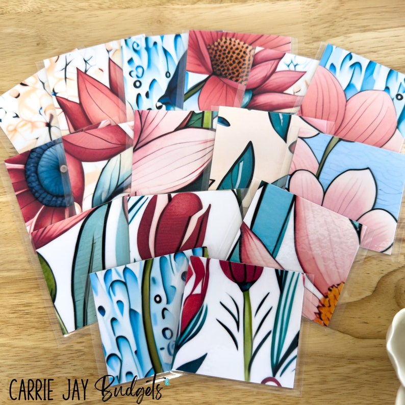 May include: A set of 12 colorful floral patterned paper cards. The cards feature a variety of flowers in shades of pink, red, blue, and green. The cards are perfect for scrapbooking, card making, or other craft projects.