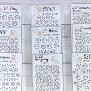 May include: A set of printable savings challenge trackers with floral designs. The trackers include options for 30 day, 26 week, 50 envelope, 100 envelope, $2000, $5000, $500, $1000 emergency fund savings challenges.