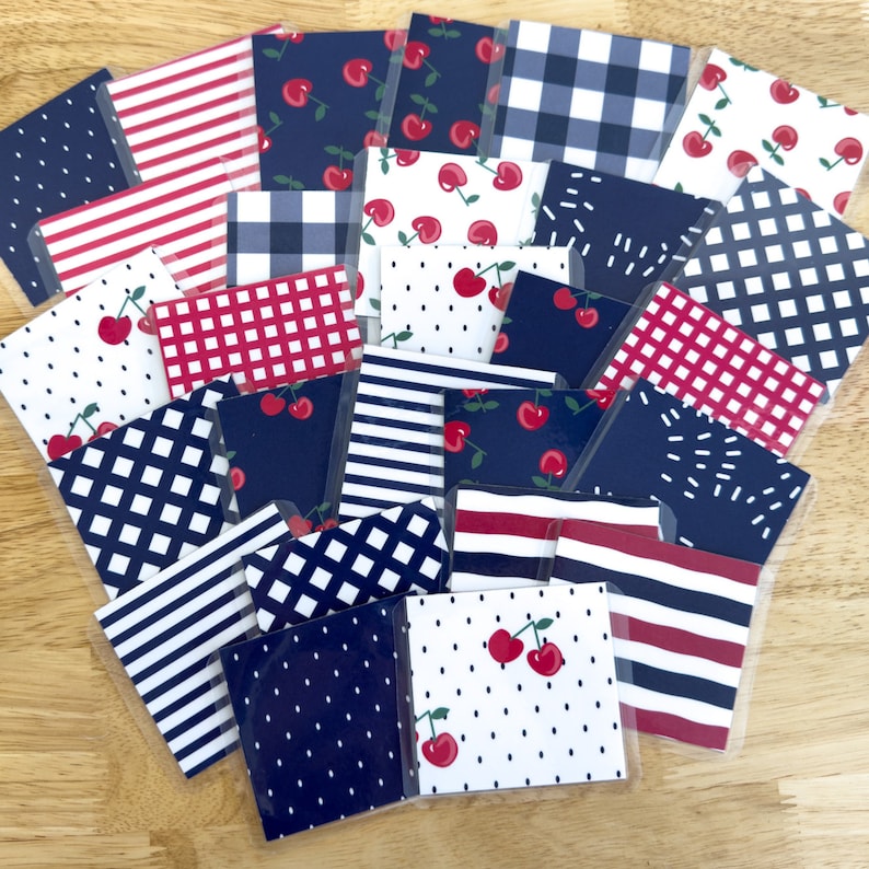 May include: A collection of 20 patterned paper squares featuring red and blue gingham, stripes, polka dots, and cherries. The papers are perfect for scrapbooking, card making, and other craft projects.