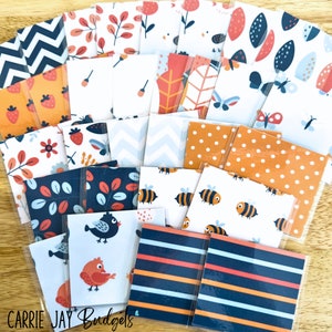 May include: A collection of 20 patterned paper squares in various colors and designs, including bees, butterflies, strawberries, leaves, and geometric patterns. The papers are arranged in a grid pattern on a wooden surface.