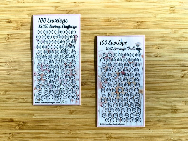 May include: Two printable 100 envelope savings challenge cards. The cards are pink with a floral design and have black circles with numbers inside. The top card says "100 Envelope $5,050 Savings Challenge" and the bottom card says "100 Envelope 10K Savings Challenge".