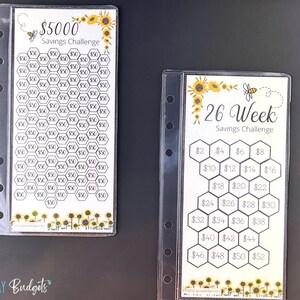 May include: Two printable savings challenge trackers with a sunflower and bee theme. The first tracker is a $5,000 savings challenge with 100 hexagons to fill in with $50 increments. The second tracker is a 26-week savings challenge with 13 hexagons to fill in with $2 increments.
