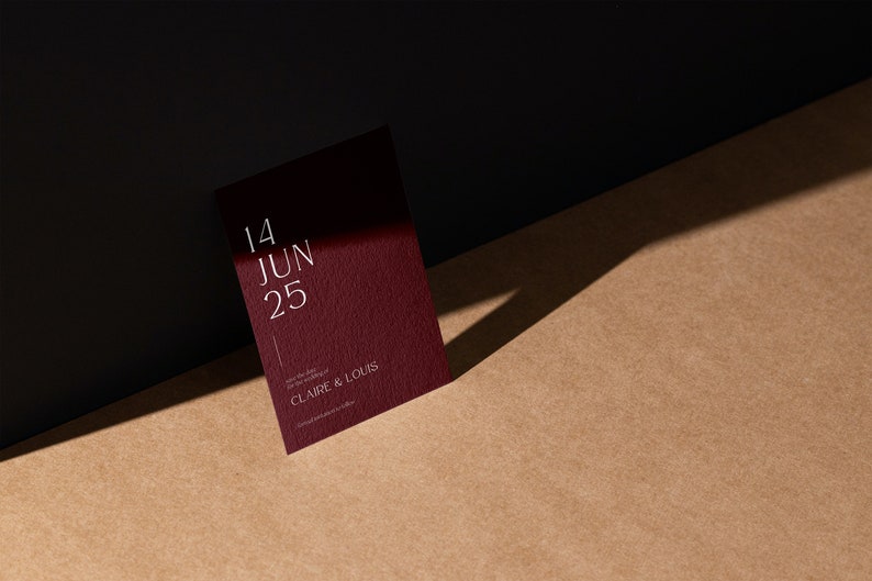 May include: A burgundy invitation card with white text that reads "14 JUN 25" and "CLAIRE & LOUIS".