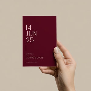 May include: A burgundy save the date card with white text that reads "14 JUN 25" and "Save the date for the wedding of CLAIRE & LOUIS. Formal invitations to follow."