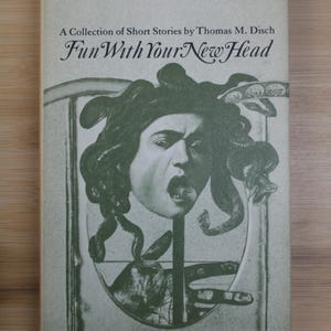 May include: A vintage paperback book titled "Fun With Your New Head" by Thomas M. Disch. The cover features a grayscale illustration of a face with Medusa-like hair. The book is part of the Doubleday Science Fiction series.