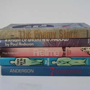 May include: A stack of six paperback books by Poul Anderson. The books are titled "The Enemy Stars", "A Knight of Ghosts and Shadows", "FireTime", "There Will Be Time", "Anderson", and "7 Conquests".