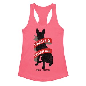 May include: A bright pink racerback tank top featuring a black silhouette of a dog facing away. A red ribbon graphic wraps around the dog with the white text CUDDLES & DESTRUCTION. Below the dog, the text STEEL + SPECTRE is printed in black.