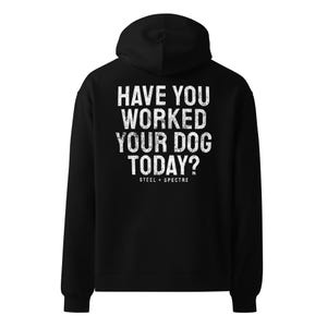 May include: Black hooded sweatshirt with the text "HAVE YOU WORKED YOUR DOG TODAY?" in distressed white lettering. The brand name "STEEL + SPECTRE" is printed below the text. The sweatshirt has a drawstring hood and long sleeves.