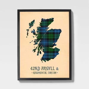 May include: Framed print featuring a map of Scotland in a blue, green, and black tartan pattern. The text "42ND ARGYLL & REGIMENTAL TARTAN" is printed at the bottom of the print. The frame is black.