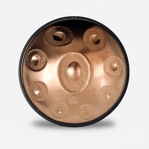 May include: A circular copper-toned steel handpan drum with a central dome and eight surrounding tone fields. The instrument features a black protective rim and the logo Zendo Sounds printed in white near the bottom edge of the metal surface.