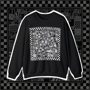 May include: Black sweatshirt with a white checkered pattern design on the front. The pattern is a repeating design of squares and circles.