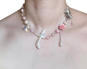May include: A delicate necklace with a pearl and shell pendant, pink and clear beads, and floral accents. The necklace features a pink rose, a pearl drop, and a silver flower charm.