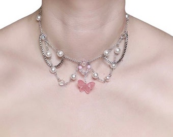 May include: A delicate silver necklace with multiple chains, pearl accents, and a pink butterfly charm.