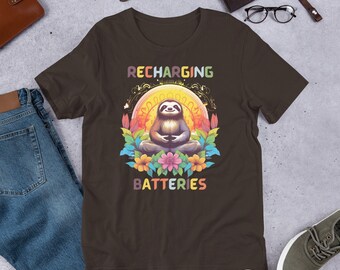 May include: A brown t-shirt with a graphic of a sloth meditating with the text "RECHARGING BATTERIES" in rainbow colors.