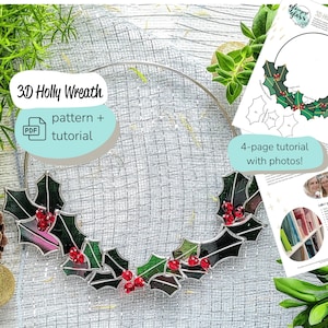 May include: A 3D stained glass holly wreath with red berries and green leaves. The wreath is made with glass pieces that are cut and assembled to create a three-dimensional effect. The wreath is hanging on a silver wire frame. The image also includes a PDF pattern and tutorial for making the wreath.