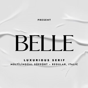 May include: A white background with a crumpled paper texture. The text "PRESENT" is at the top of the image. The word "BELLE" is in a large, bold, black font. Below the word "BELLE" is the text "LUXURIOUS SERIF" and "MULTILINGUAL SUPPORT - REGULAR, ITALIC".