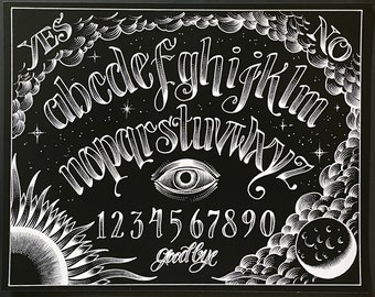 May include: A black and white Ouija board with a stylized alphabet, numbers 1-9 and 0, the words "YES" and "NO" at the top, and the word "Goodbye" at the bottom. The board also features a stylized eye and a sun and moon design.