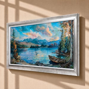 May include: A rectangular landscape painting in a silver frame depicting a calm blue lake surrounded by dense green trees and distant mountains under a sky filled with pink, orange, and blue clouds, with a small wooden rowboat moored near the shore.