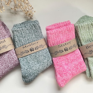May include: Four pairs of cozy socks with different colors and labels. The labels read "Best Friend", "Mother", "Sister", and "Best Friend".