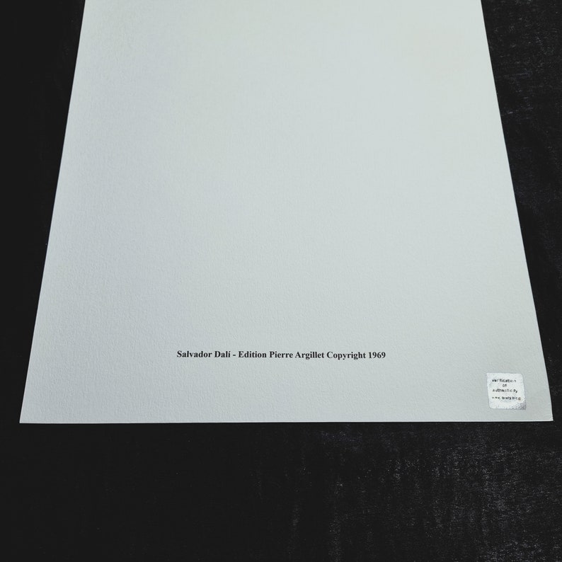 May include: A white sheet of paper with the text "Salvador Dali - Edition Pierre Argillet Copyright 1969" printed in black ink at the bottom.