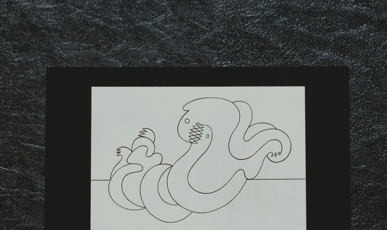 May include: Black and white line drawing of an abstract, organic shape resembling a creature with multiple limbs. The shape is drawn on a white background and framed with a black border.