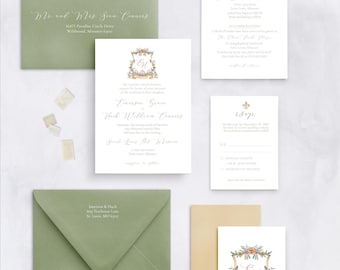 May include: Wedding invitation suite with green and gold envelopes. The invitation features a floral crest with the initials "E & H" and the text "Emerson & Hayes". The RSVP card has a gold fleur-de-lis design.