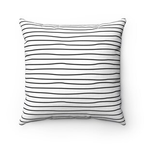 May include: White throw pillow with black horizontal stripes.