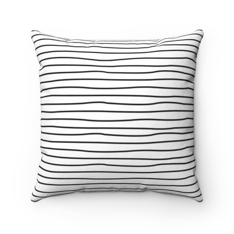 May include: White throw pillow with black horizontal stripes.