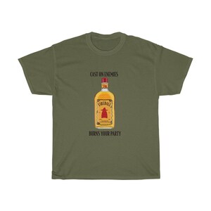 May include: A green t-shirt with the text "Cast on enemies" and "Burns your party" printed on it. A bottle of Fireball whiskey is pictured in the centre of the shirt.