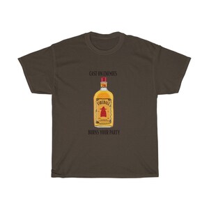 May include: A brown t-shirt with the text "Cast on enemies" and "Burns your party" printed on it. A bottle of Fireball whiskey is pictured in the centre of the shirt.