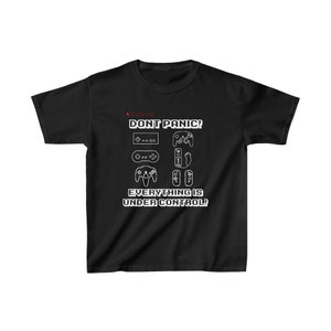 May include: Black t-shirt with a white graphic of various video game controllers and the text "DON'T PANIC! EVERYTHING IS UNDER CONTROL!"