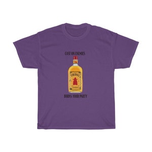 May include: Purple t-shirt featuring a graphic of a Fireball whiskey bottle with the text "Cast on enemies, burns your party."