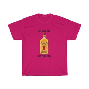 May include: Pink t-shirt featuring a graphic of a Fireball whiskey bottle with the text "Cast on enemies, burns your party."