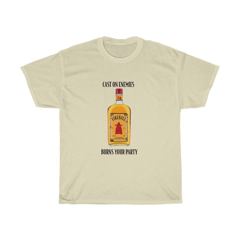 May include: A beige t-shirt featuring the text "Cast on enemies" and a Fireball whiskey bottle graphic. The text "Burns your party" is positioned below the graphic.