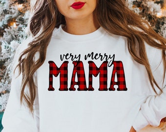 Op de afbeelding: Witte trui met de tekst "very merry MAMA" in rood-zwart buffalo plaid.
