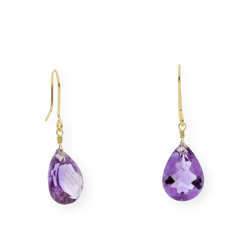 May include: A pair of gold dangle earrings with purple amethyst teardrop-shaped stones.