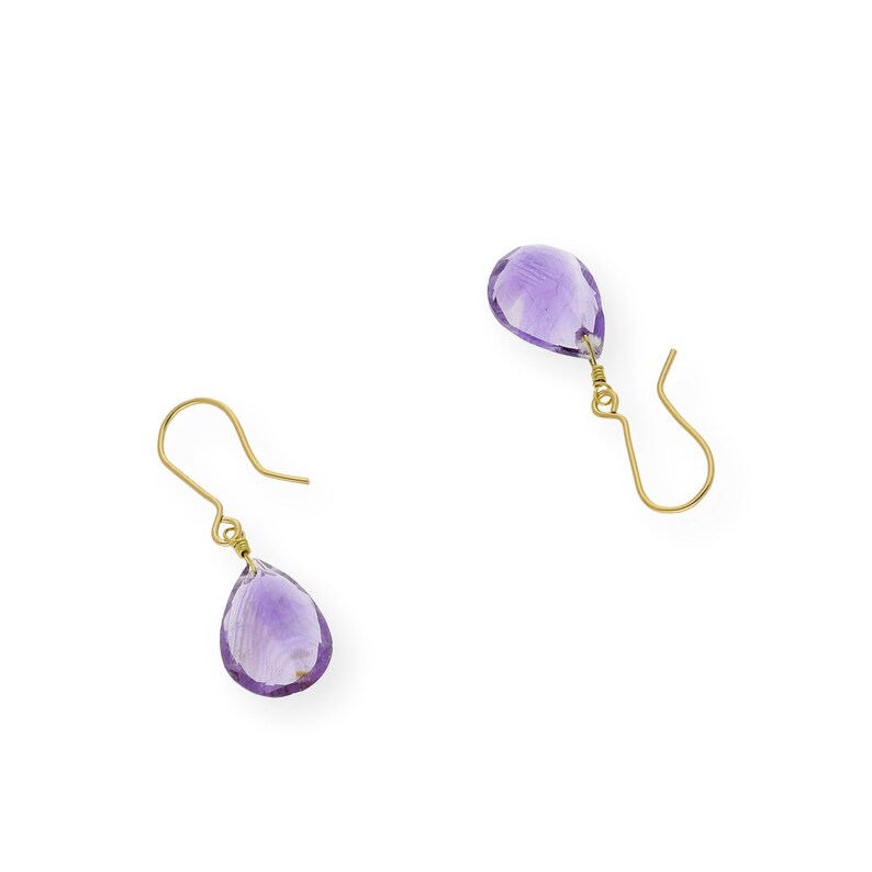 May include: A pair of gold earrings with teardrop-shaped amethyst stones.