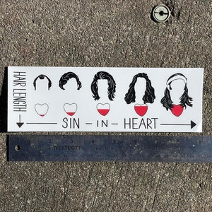 May include: A white sticker with black and red illustrations of five hairstyles with hearts underneath. The text "HAIR LENGTH" is on the left side of the sticker. The text "SIN - IN - HEART" is below the hearts.