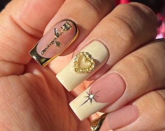 Gold goddess | Ivory french tips w/ gold rose,heart gem accents | Winter Valentine’s Day | Apres gel x | med square