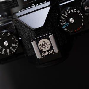 Svart Nikon-skydd för blixtsko